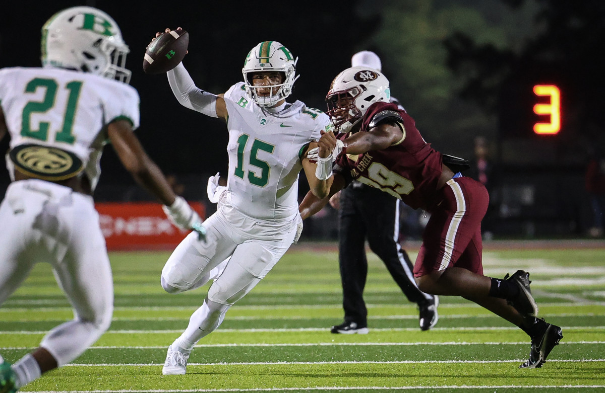 Buford QB Dylan Raioloa (15) escapes the rush of Mill Creek's Elan Baugham (19). 11/13/2023